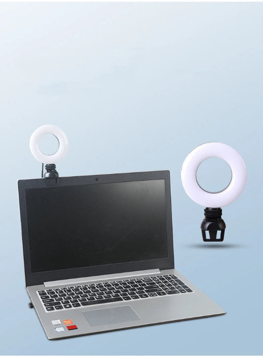 Laptop with ring lights on a light blue background