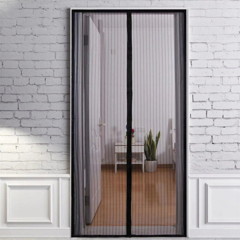 Magnetic screen door on a glass door with a white brick wall background
