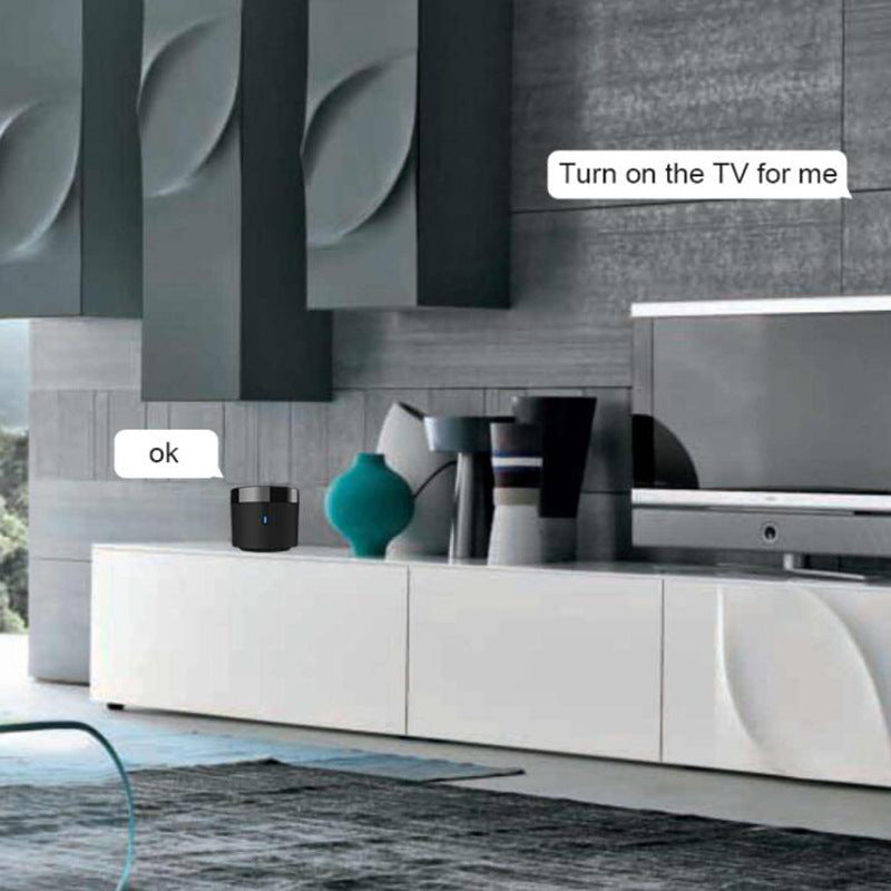 Modern living room with a TV and a control device on a white cabinet.