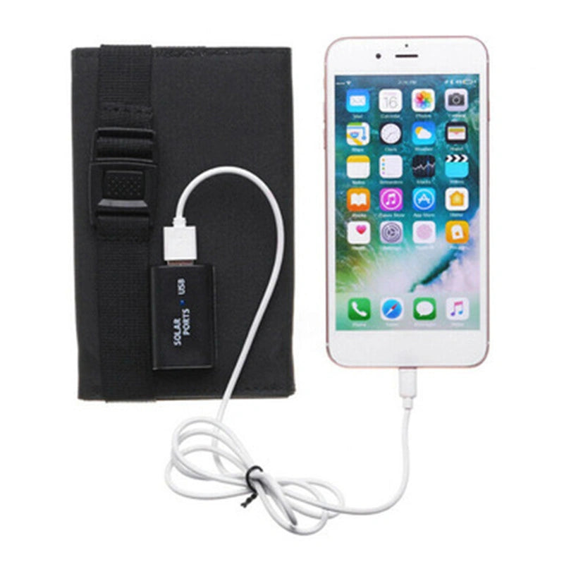 Black solar panel with USB cable connected to a smartphone on a white background
