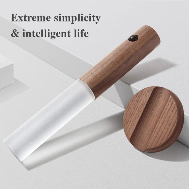 Wooden tool with white handle on a light gray background, text 'Extreme simplicity & intelligent life' above.
