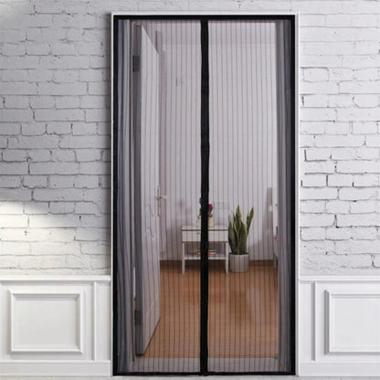 Magnetic screen door on a glass door with a white brick wall background