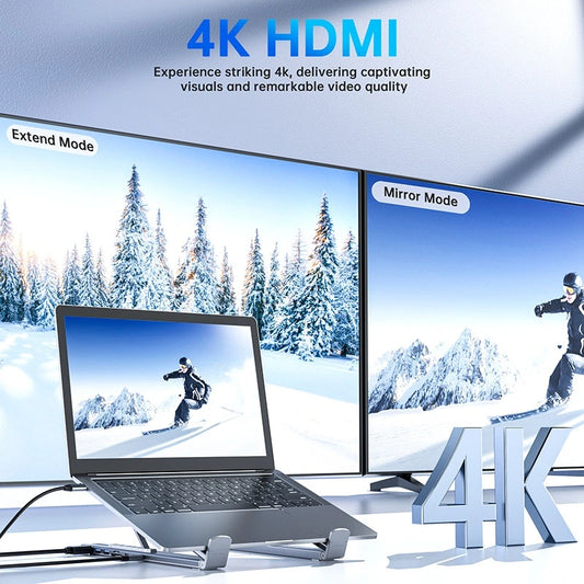 Laptop with dual monitors displaying snowy landscape and skier, emphasizing 4K HDMI technology.
