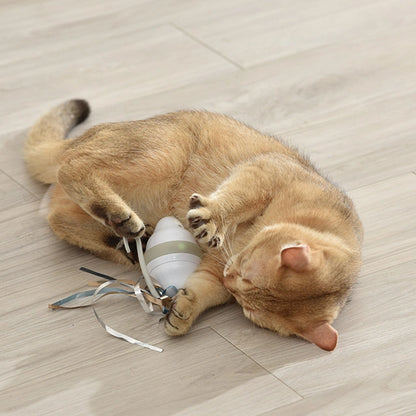 Cat playing with a toy on a wooden floor